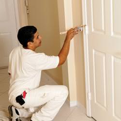 An interior painting contractor detailing a home with paint in Brookfield